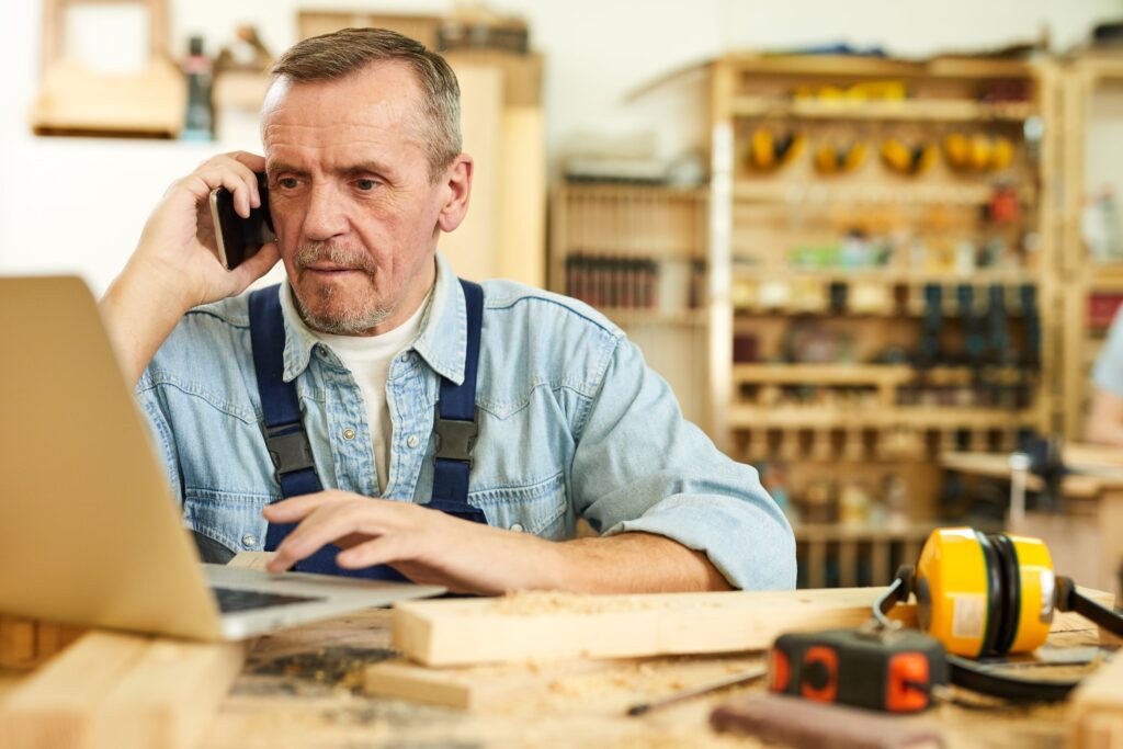 Stock image of man working on a computer in a workshop