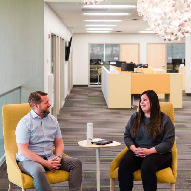photograph of two employees sitting in an office