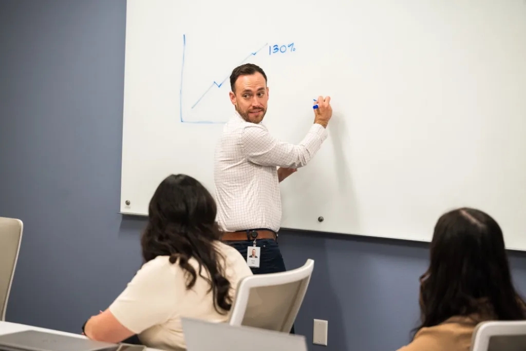 Teacher writing on the whiteboard